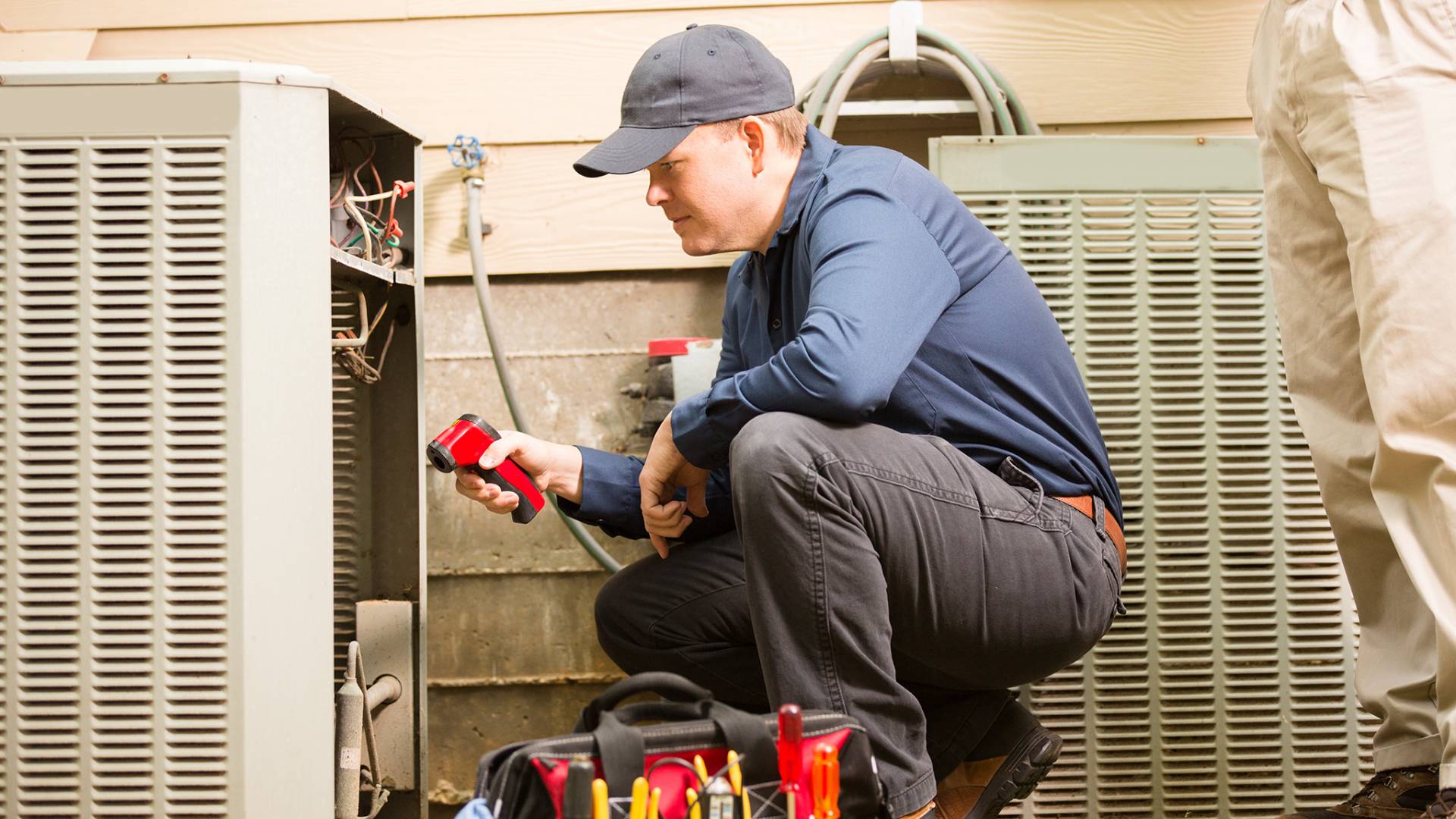 HVAC technician using his tools on a HVAC unit