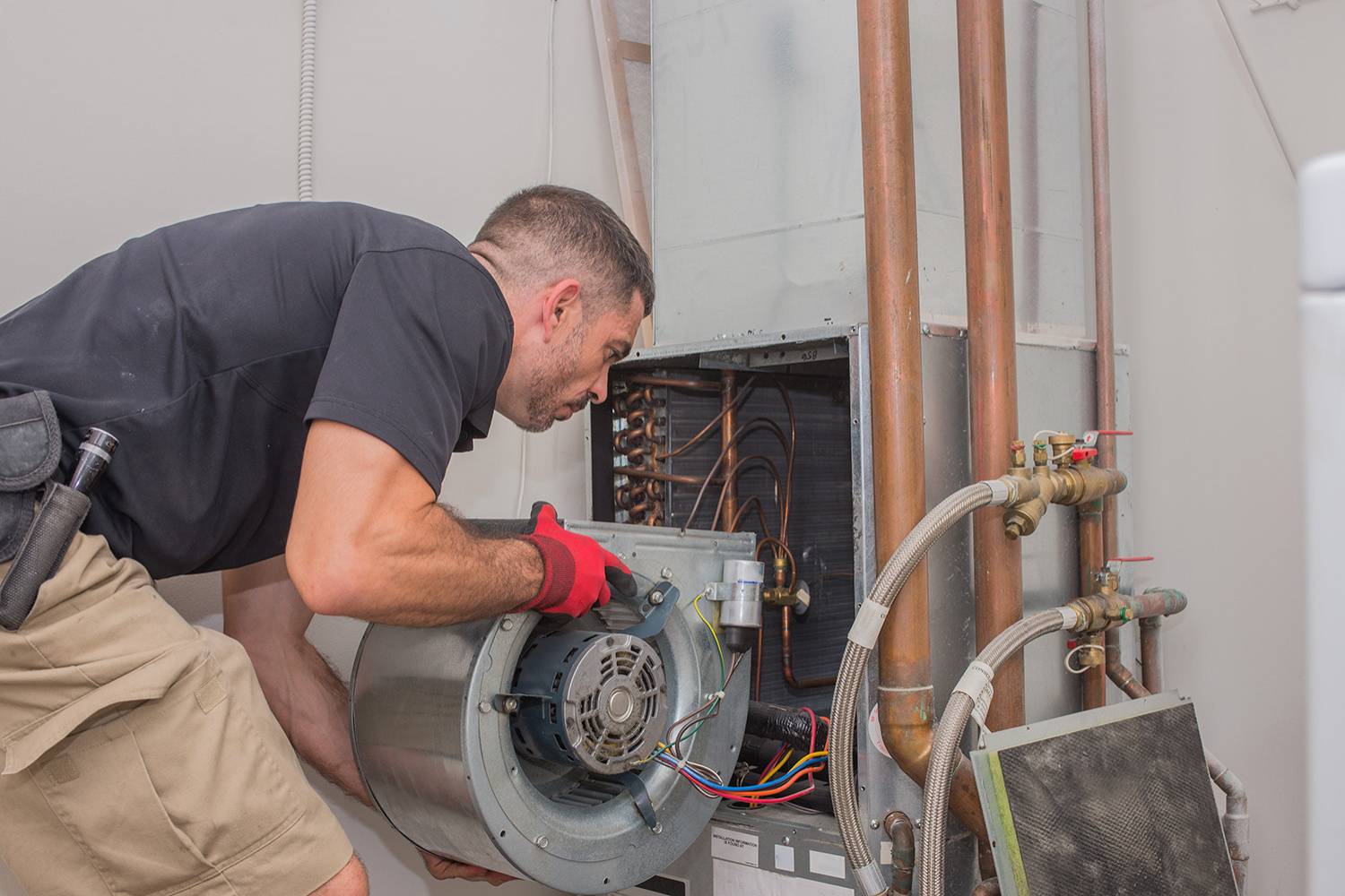 hvac repair service tech removing a air handler blower motor