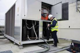 an refrigeration repair technician fixing a commercial refrigerator unit